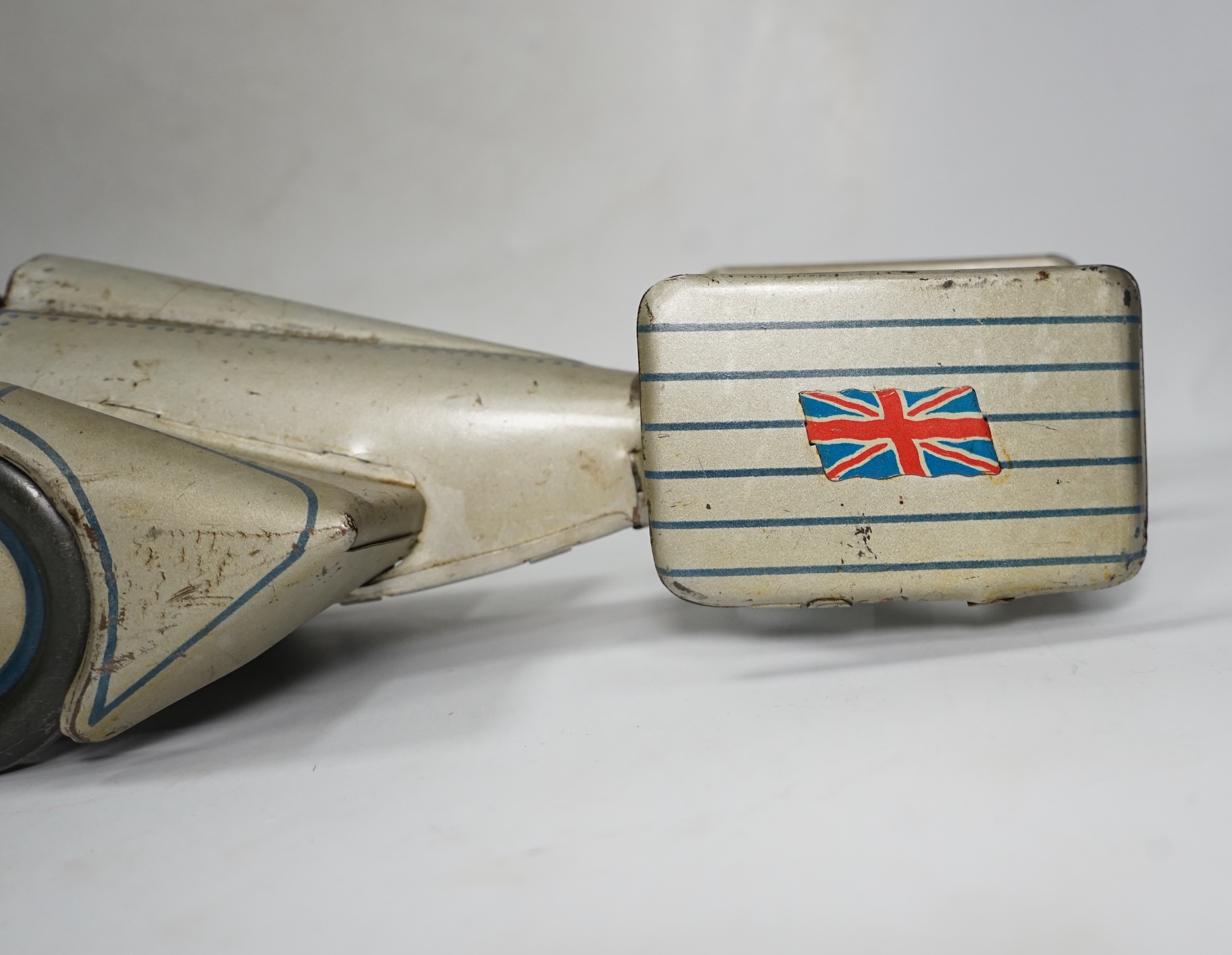 A 1930s Gunthermann (Germany) clockwork tinplate Sunbeam Silver Bullet world record car, with blue printed panel and rivet detail, driver, and Union flags to tail fins, stamped with ‘Foreign’ to underside, 56cm long. Con